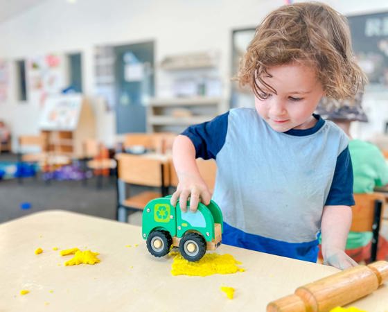 Evolve Education Preschool boy playing with care and playdough at daycare