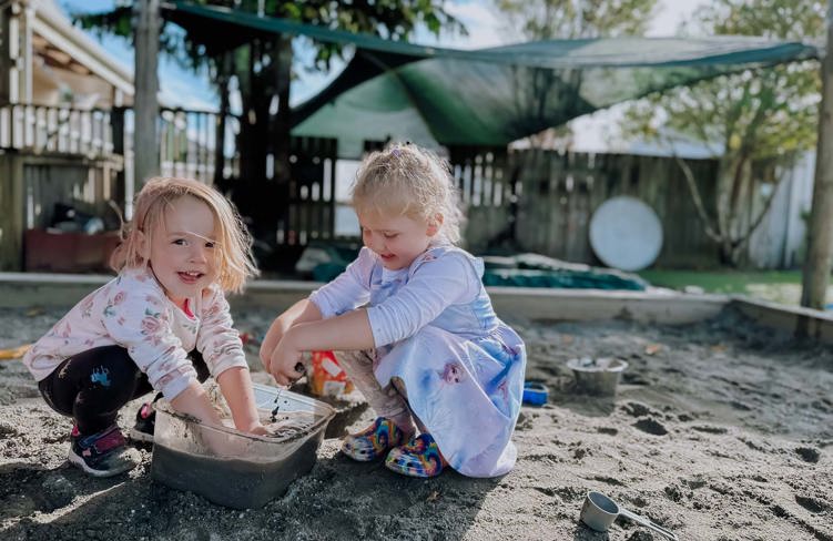 Evolve Education Preschool girls playing in sandpit at daycare