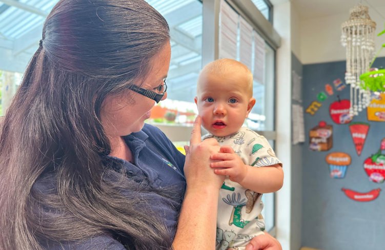 Evolve Education Teacher holding baby