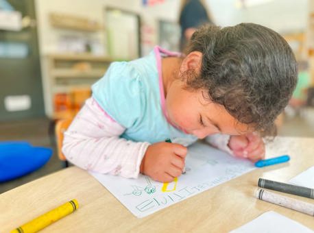Evolve Education Preschool girl drawing on paper at daycare